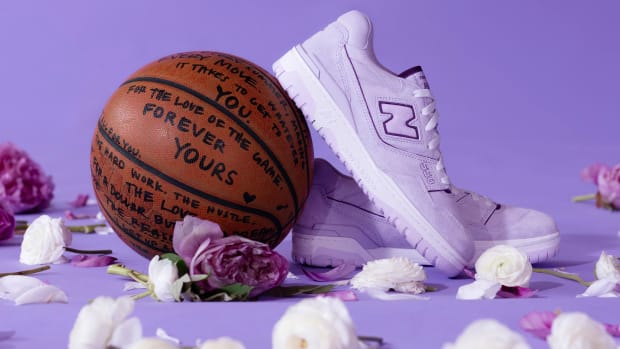A purple and white New Balance sneaker on a basketball.